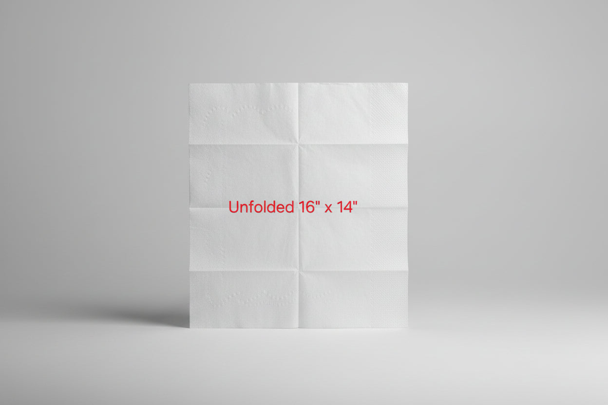 Unfolded white paper towel sheet on a brown surface with text indicating size.